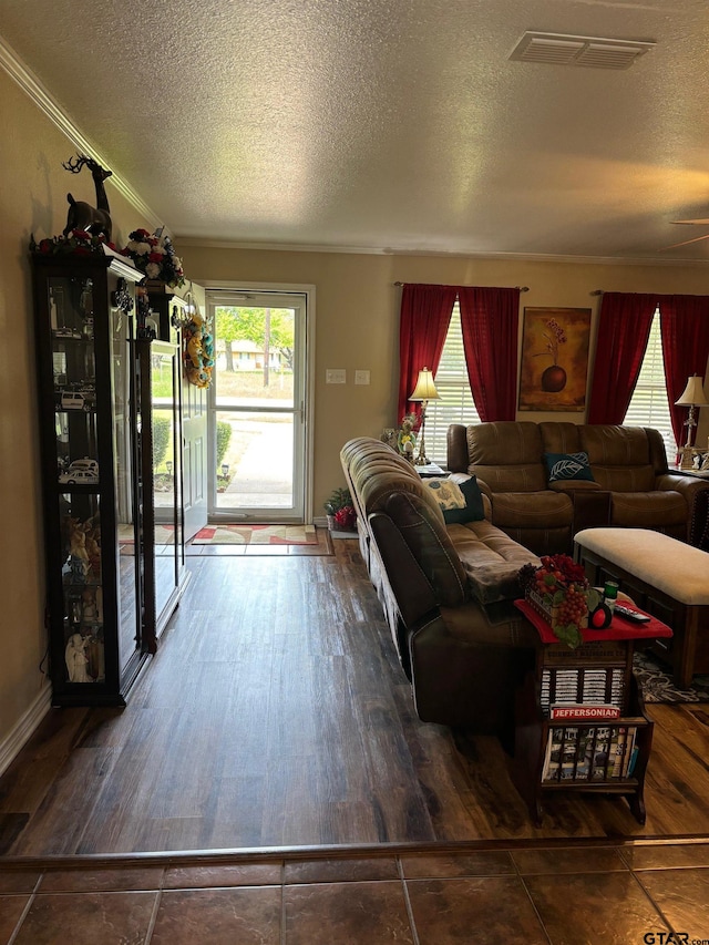 living room featuring a wealth of natural light, a textured ceiling, and hardwood / wood-style flooring