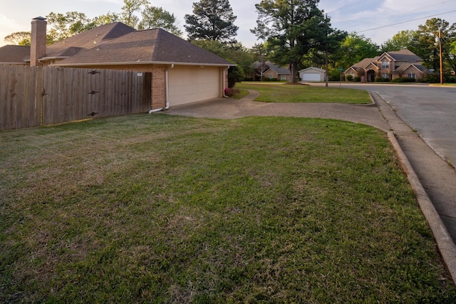 1621 Cimmarron Trl, Tyler, TX 75703 - view of yard with fence, a garage, and concrete driveway
