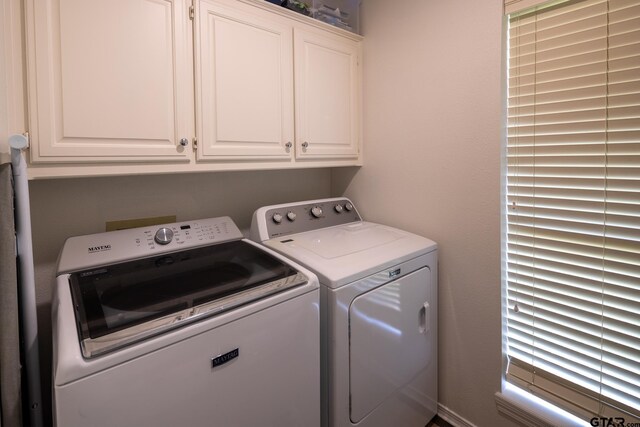 1621 Cimmarron Trl, Tyler, TX 75703 - laundry area with cabinet space and independent washer and dryer