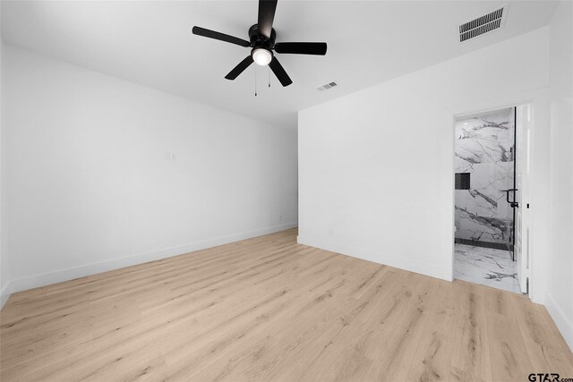 spare room featuring light hardwood / wood-style flooring and ceiling fan