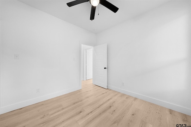 empty room with ceiling fan and light hardwood / wood-style flooring