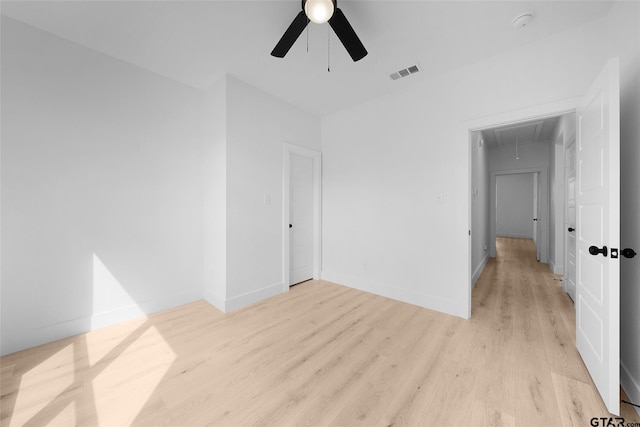 empty room with light hardwood / wood-style floors and ceiling fan