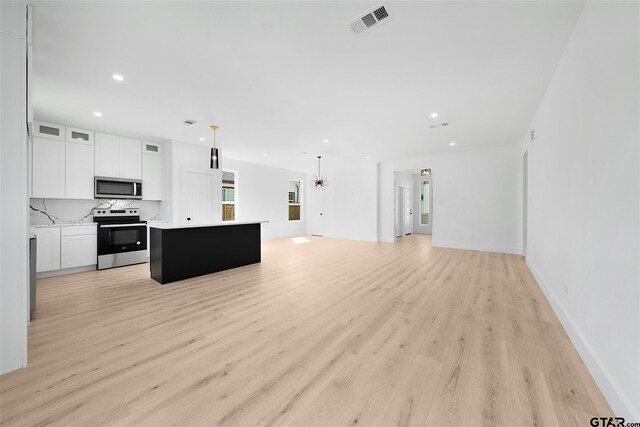 kitchen with stainless steel appliances, light hardwood / wood-style floors, hanging light fixtures, a kitchen island, and white cabinetry