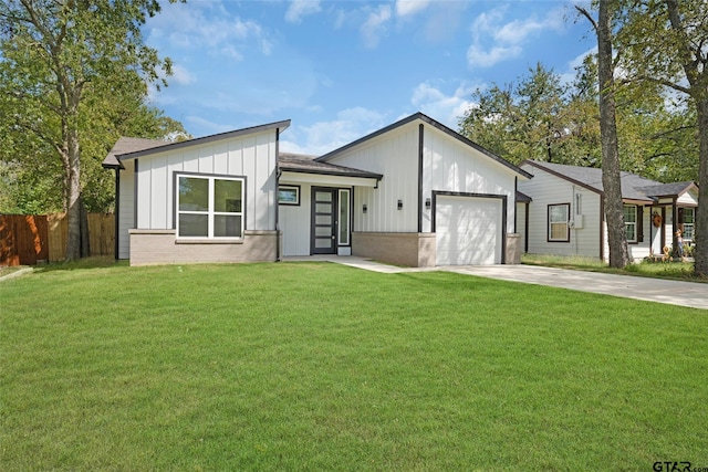 view of front of home with a garage and a front lawn