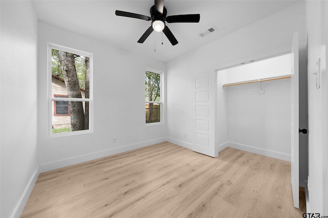 unfurnished bedroom featuring light hardwood / wood-style floors, ceiling fan, and a closet