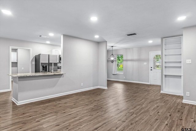 1004 Bunny Rabbit Rd, Athens, TX 75751 - unfurnished living room with dark wood-type flooring and recessed lighting