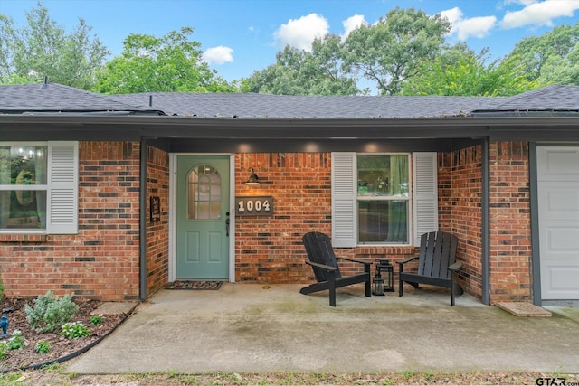 1004 Bunny Rabbit Rd, Athens, TX 75751 - property entrance with brick siding, roof with shingles, and a patio area