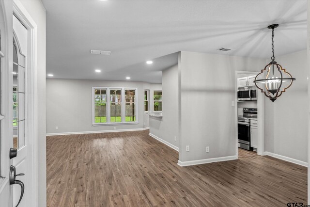 1004 Bunny Rabbit Rd, Athens, TX 75751 - unfurnished living room with wood finished floors, a chandelier, and recessed lighting