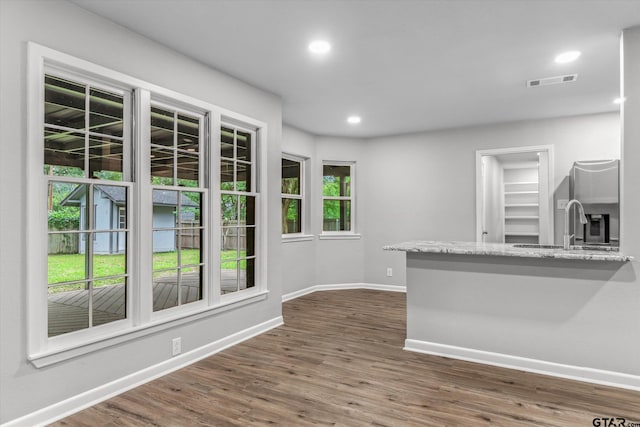 1004 Bunny Rabbit Rd, Athens, TX 75751 - kitchen with stainless steel refrigerator with ice dispenser, dark wood-style floors, recessed lighting, and light stone counters