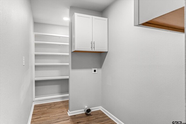1004 Bunny Rabbit Rd, Athens, TX 75751 - laundry area with hookup for an electric dryer, dark wood finished floors, and cabinet space