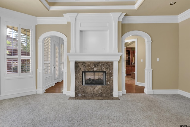 6805 Castle Pines Ct, Tyler, TX 75703 - unfurnished living room with carpet, crown molding, arched walkways, and a premium fireplace