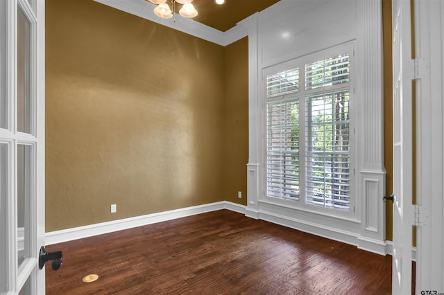6805 Castle Pines Ct, Tyler, TX 75703 - empty room with dark wood-style floors, a chandelier, baseboards, and crown molding