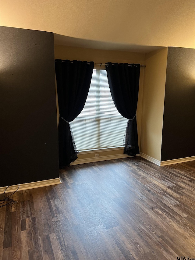 unfurnished room featuring dark hardwood / wood-style floors