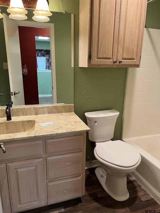 bathroom with vanity, wood-type flooring, and toilet