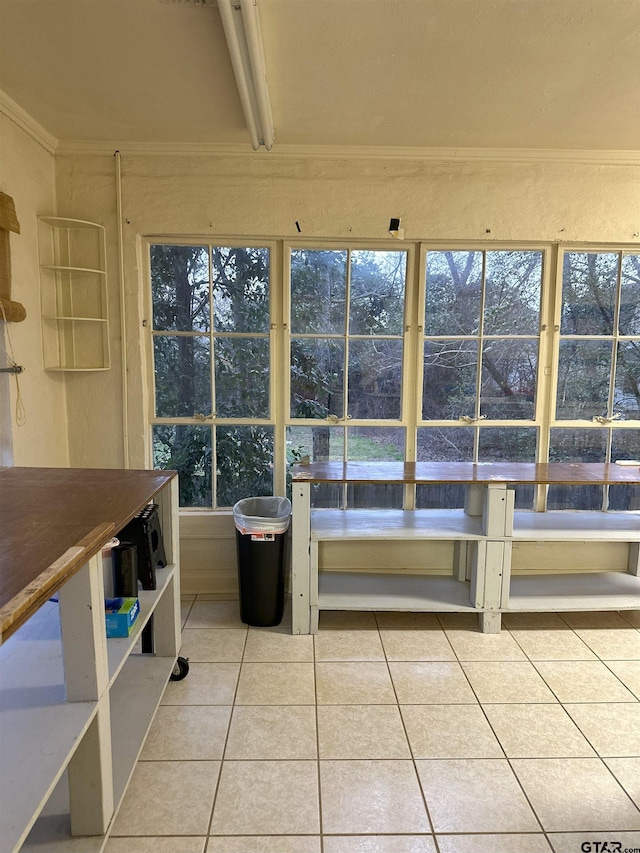 unfurnished sunroom with beam ceiling