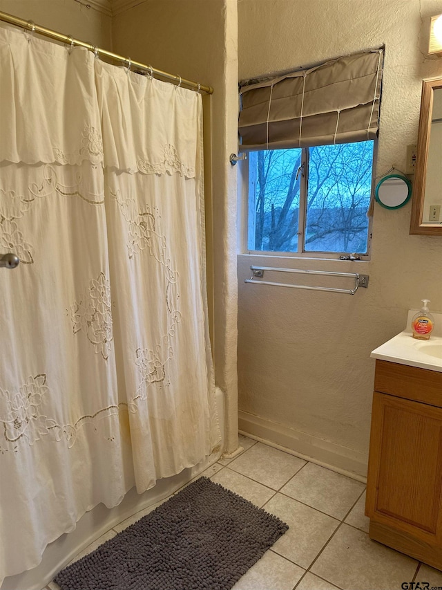 bathroom with shower / bath combo, vanity, and tile patterned floors