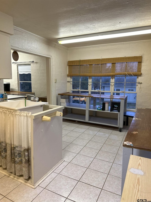 kitchen with a textured ceiling and light tile patterned flooring