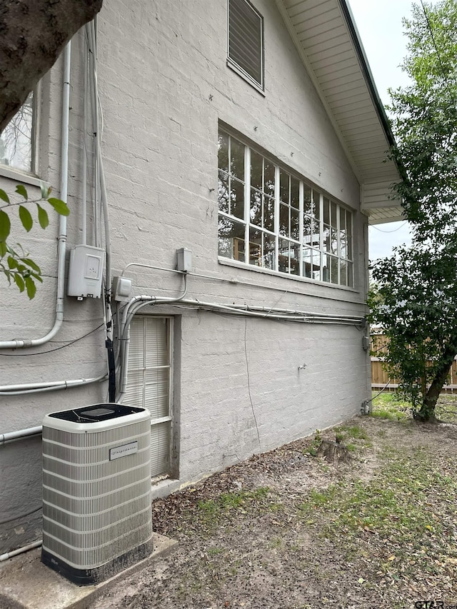 view of side of property featuring central AC