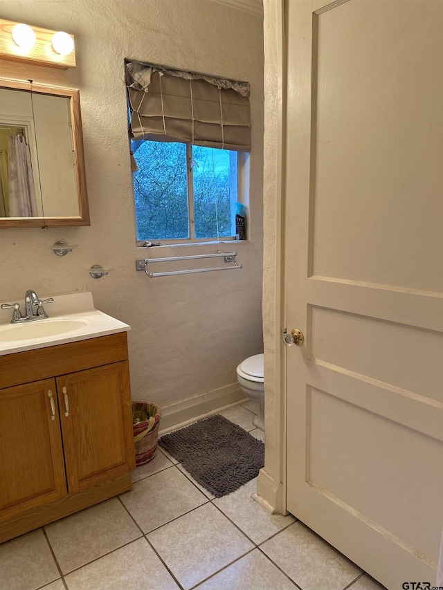 bathroom with vanity, tile patterned floors, and toilet