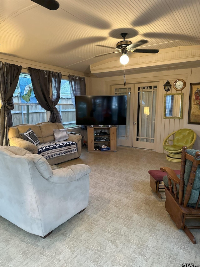 living room with ceiling fan and lofted ceiling