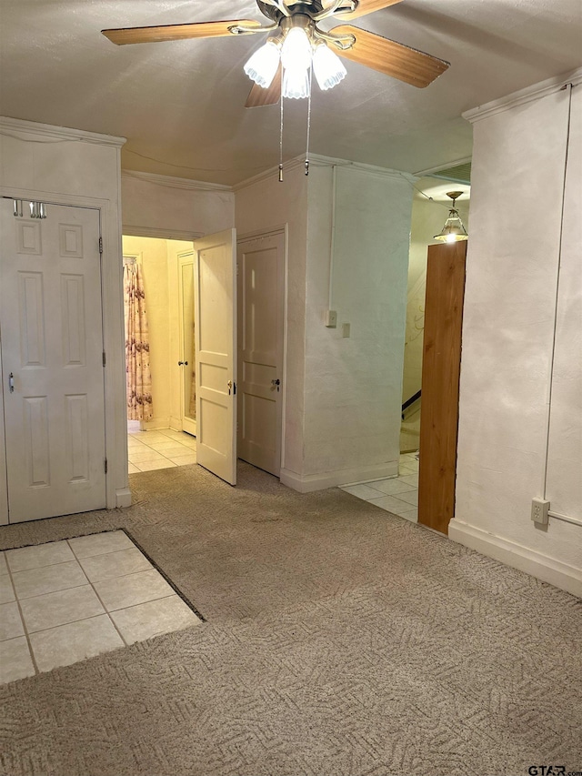 unfurnished room with ceiling fan and light colored carpet