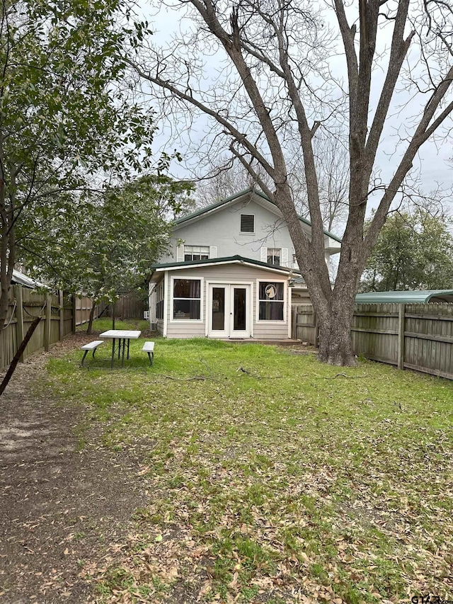 rear view of house featuring a lawn