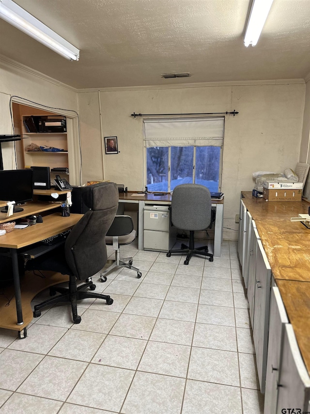 office featuring ornamental molding, a textured ceiling, and light tile patterned flooring