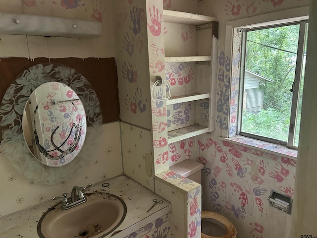 524 E San Antonio St, Alto, TX 75925 - bathroom with a sink, plenty of natural light, wallpapered walls, and toilet
