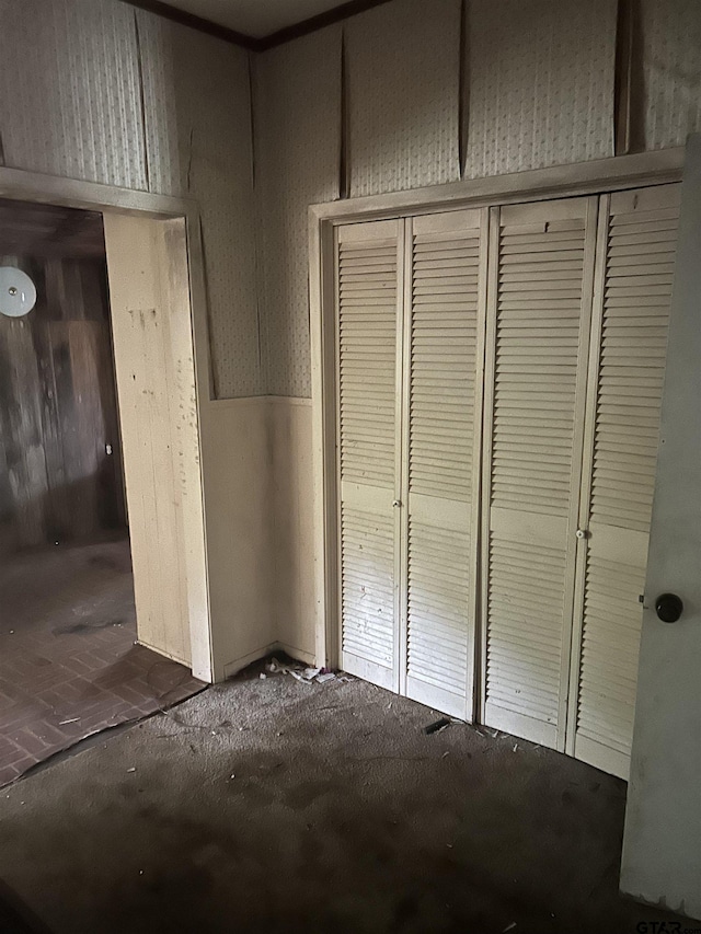 524 E San Antonio St, Alto, TX 75925 - unfurnished bedroom with a closet and wood walls