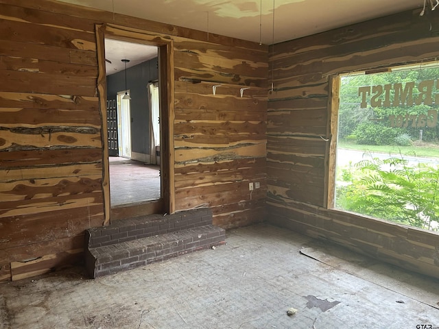 524 E San Antonio St, Alto, TX 75925 - unfurnished room with healthy amount of natural light and wood walls