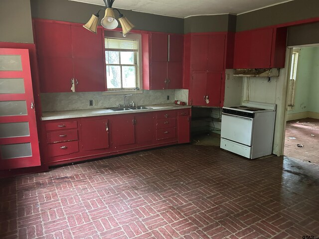 524 E San Antonio St, Alto, TX 75925 - kitchen with red cabinets, electric range, a sink, and brick patterned flooring