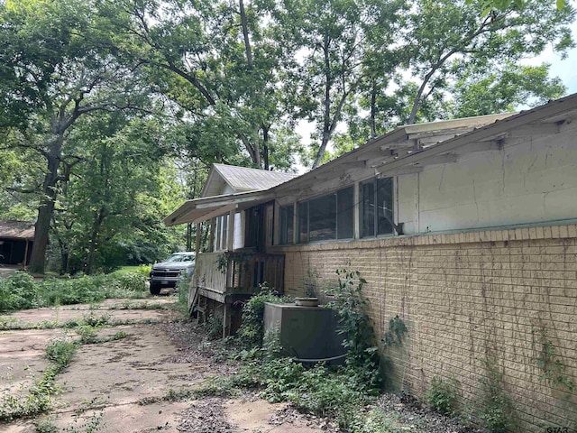 524 E San Antonio St, Alto, TX 75925 - view of property exterior with brick siding, driveway, and cooling unit