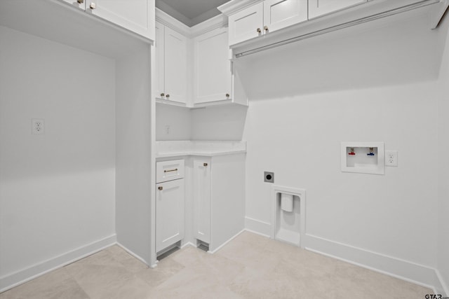 clothes washing area with cabinets, washer hookup, and hookup for an electric dryer