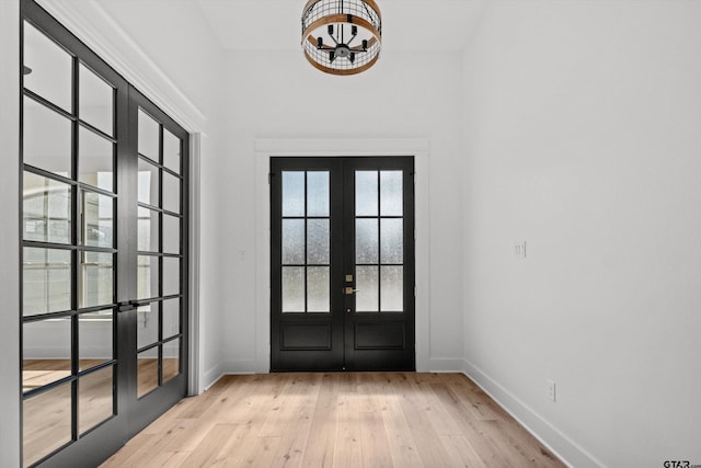 doorway to outside featuring french doors and light wood-type flooring