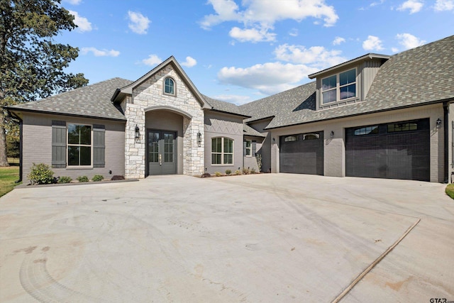 french country inspired facade featuring french doors and a garage