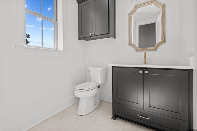 bathroom with tile patterned flooring, vanity, and toilet