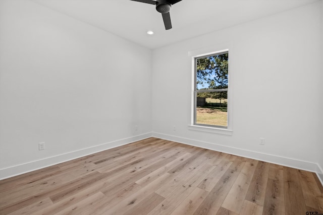 spare room featuring ceiling fan and light hardwood / wood-style flooring