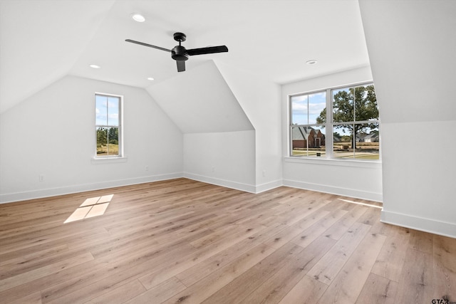 additional living space with light hardwood / wood-style flooring, plenty of natural light, lofted ceiling, and ceiling fan