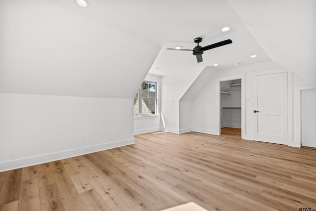 additional living space featuring light wood-type flooring, ceiling fan, and lofted ceiling