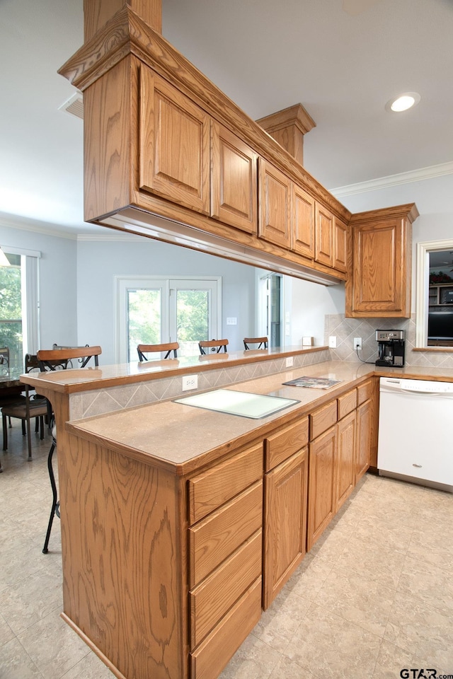 11831 Smallwood Dr, Flint, TX 75762 - kitchen with white dishwasher, tasteful backsplash, ornamental molding, a peninsula, and a kitchen breakfast bar