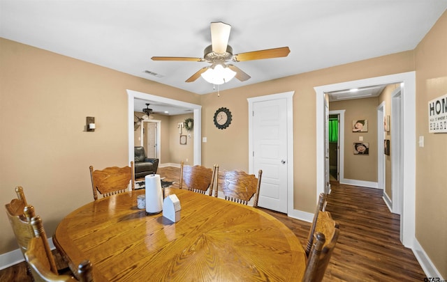 dining space featuring ceiling fan and dark wood-type flooring