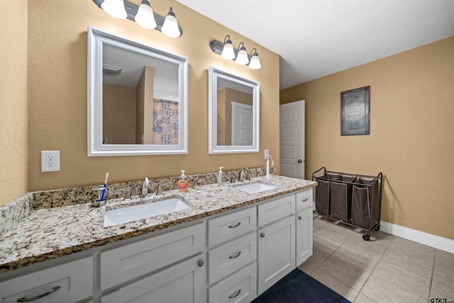 bathroom with tile patterned flooring and vanity