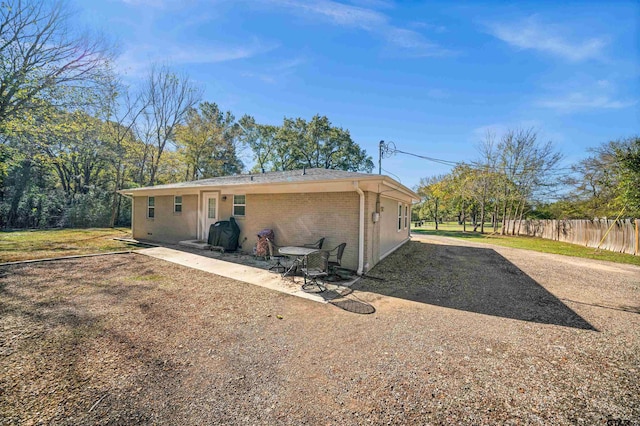 rear view of property featuring a patio area