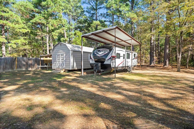 view of yard featuring a carport and a storage shed