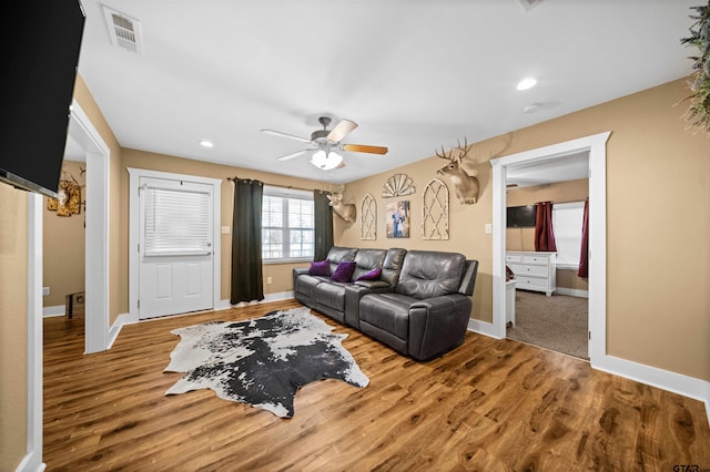 living room featuring ceiling fan and wood-type flooring