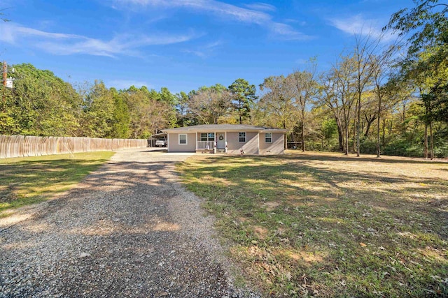 single story home featuring a front lawn and a carport