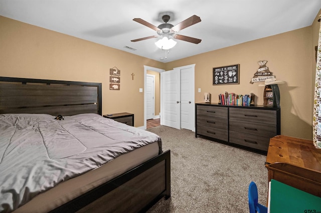 bedroom featuring ceiling fan and light carpet