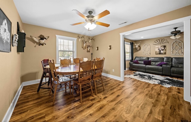 dining room with hardwood / wood-style floors and ceiling fan