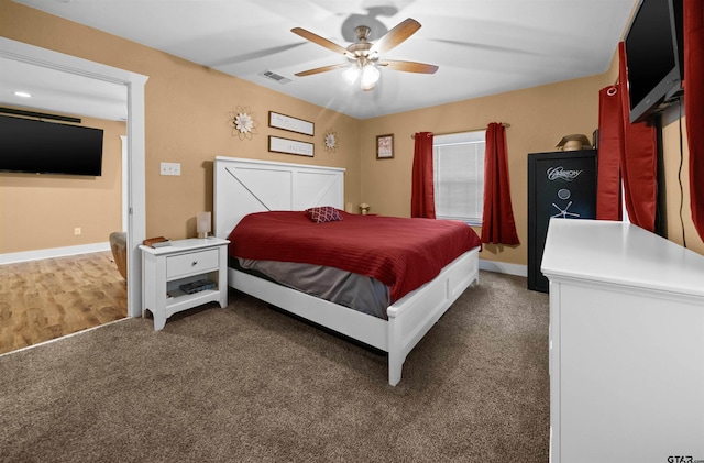 bedroom featuring ceiling fan and dark carpet