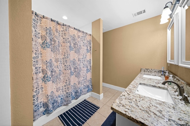 bathroom featuring tile patterned flooring and vanity